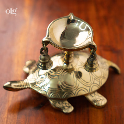 Brass turtle-shaped diya lamp with hanging bells, home decor