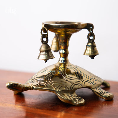 Brass turtle-shaped diya lamp with hanging bells, home decor