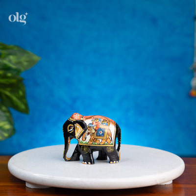 Hand-painted black wooden elephant figurine with miniature painting detail
