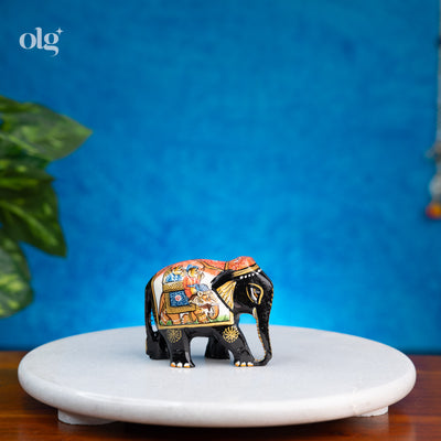 Hand-painted black wooden elephant figurine with miniature painting detail