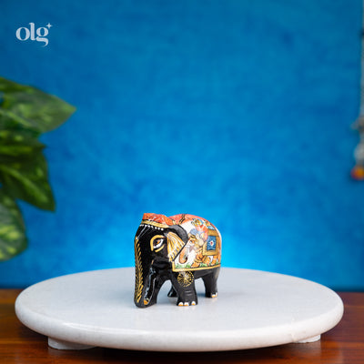 Hand-painted black wooden elephant figurine with miniature painting detail