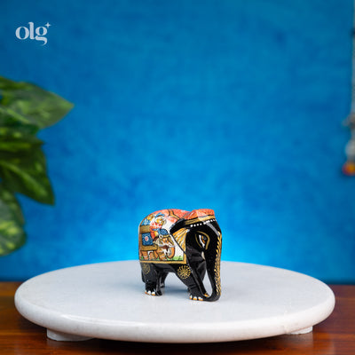 Hand-painted black wooden elephant figurine with miniature painting detail