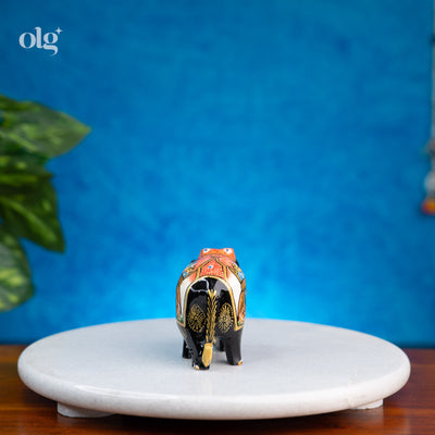 Hand-painted black wooden elephant figurine with miniature painting detail