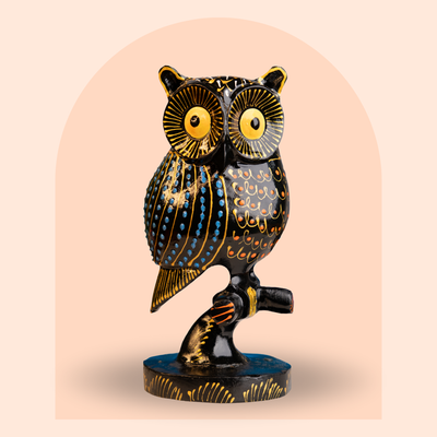 Hand-painted black and gold kadam wood owl figurine on branch, 6 inch
