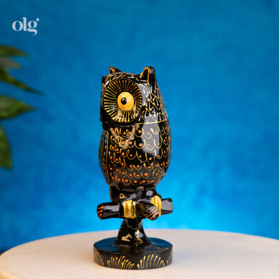 Hand-painted black and gold kadam wood owl figurine on branch, 6 inch