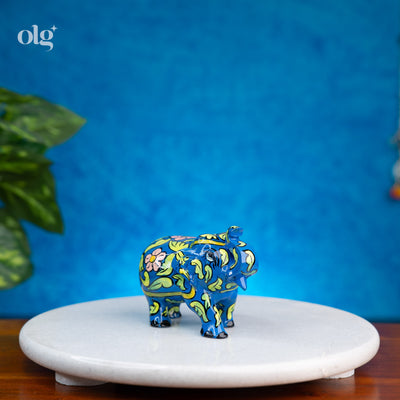 Hand-painted blue wooden elephant figurine with floral and vine art