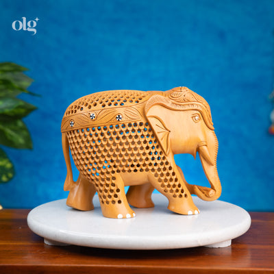 Hand-carved wooden elephant figurine with intricate jali lattice work