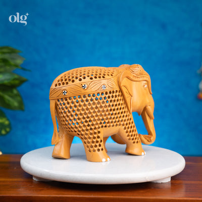 Hand-carved wooden elephant figurine with intricate jali lattice work