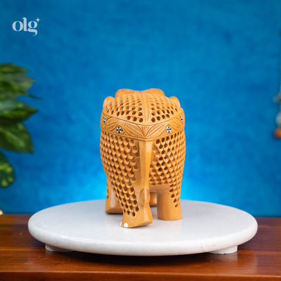 Hand-carved wooden elephant figurine with intricate jali lattice work