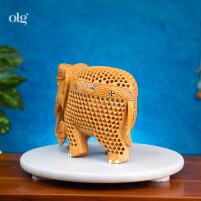 Hand-carved wooden elephant figurine with intricate jali lattice work