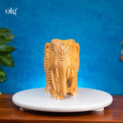 Hand-carved wooden elephant figurine with intricate jali lattice work