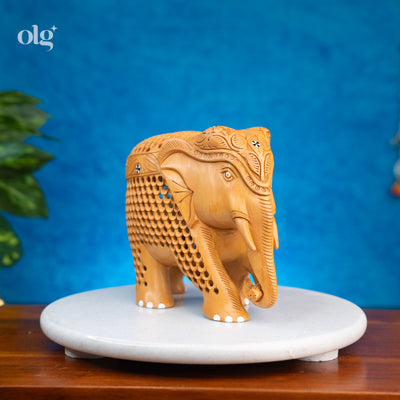 Hand-carved wooden elephant figurine with intricate jali lattice work