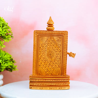 Hand-carved wooden Ganesha idol holding a flute