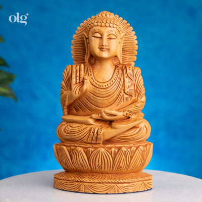 Wooden meditating Buddha figurine in abhaya mudra on lotus base