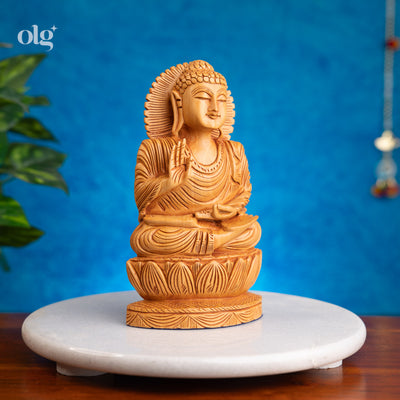 Wooden meditating Buddha figurine in abhaya mudra on lotus base